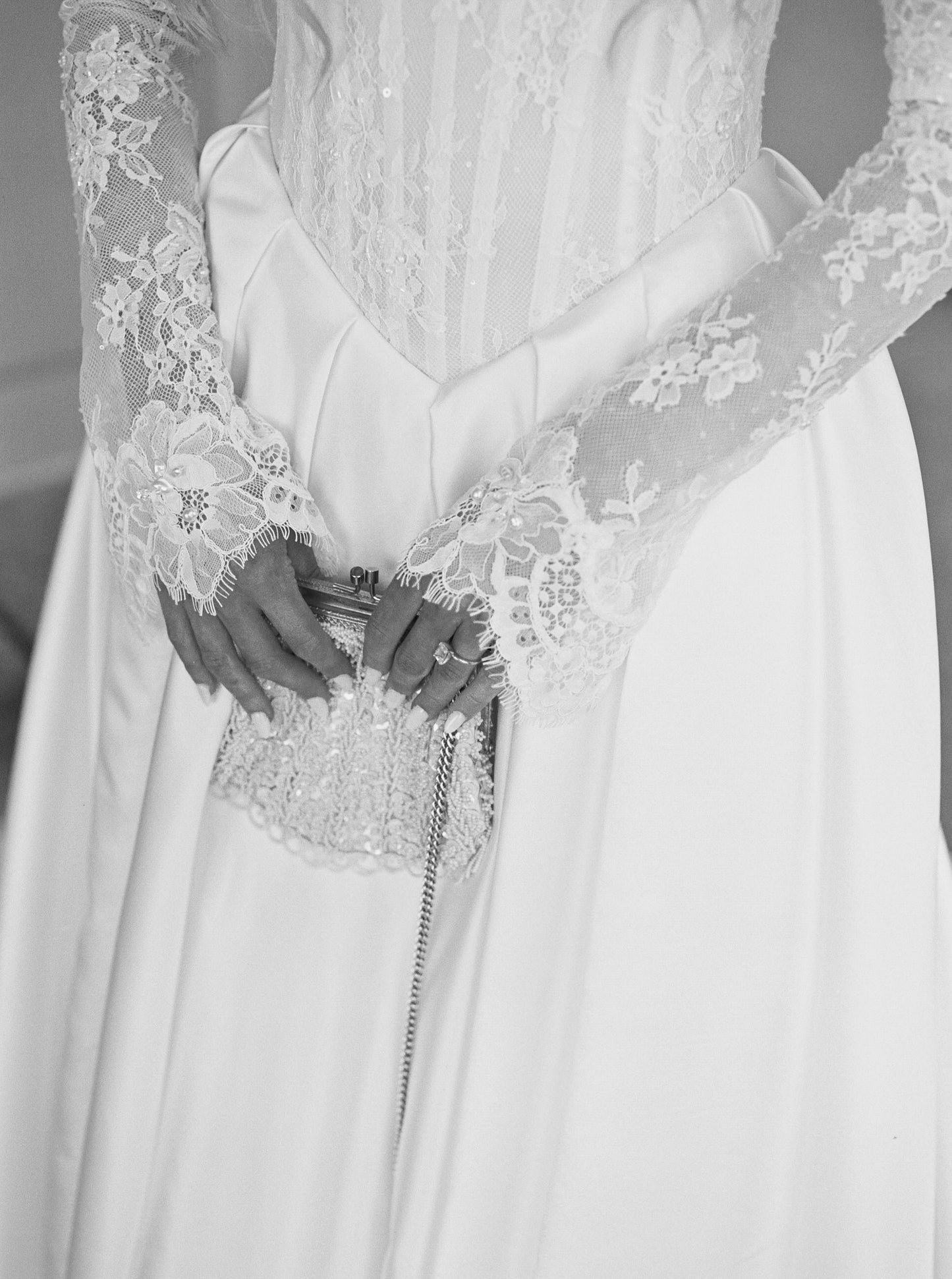 beaded small bridal clutch and chantilly lace glove sleeves on bride in Basque waist corset gown