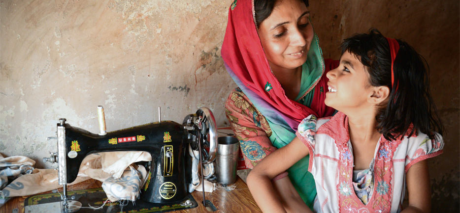 woman and daughter at sewing machine in India
