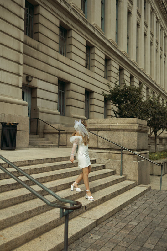 short wedding veil and minidress on bride in platform heels and puff sleeve gloves
