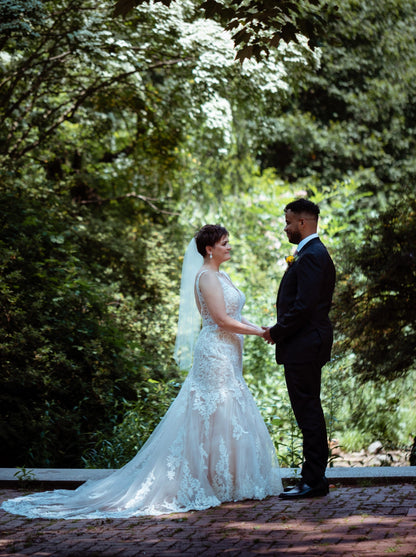 simple raw edge bridal veil fingertip length in blush on short haired bride in the woods