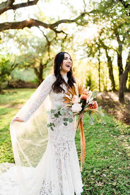 bohemian chic lace long sleeve gown with whimsical starry moon and star wedding cape