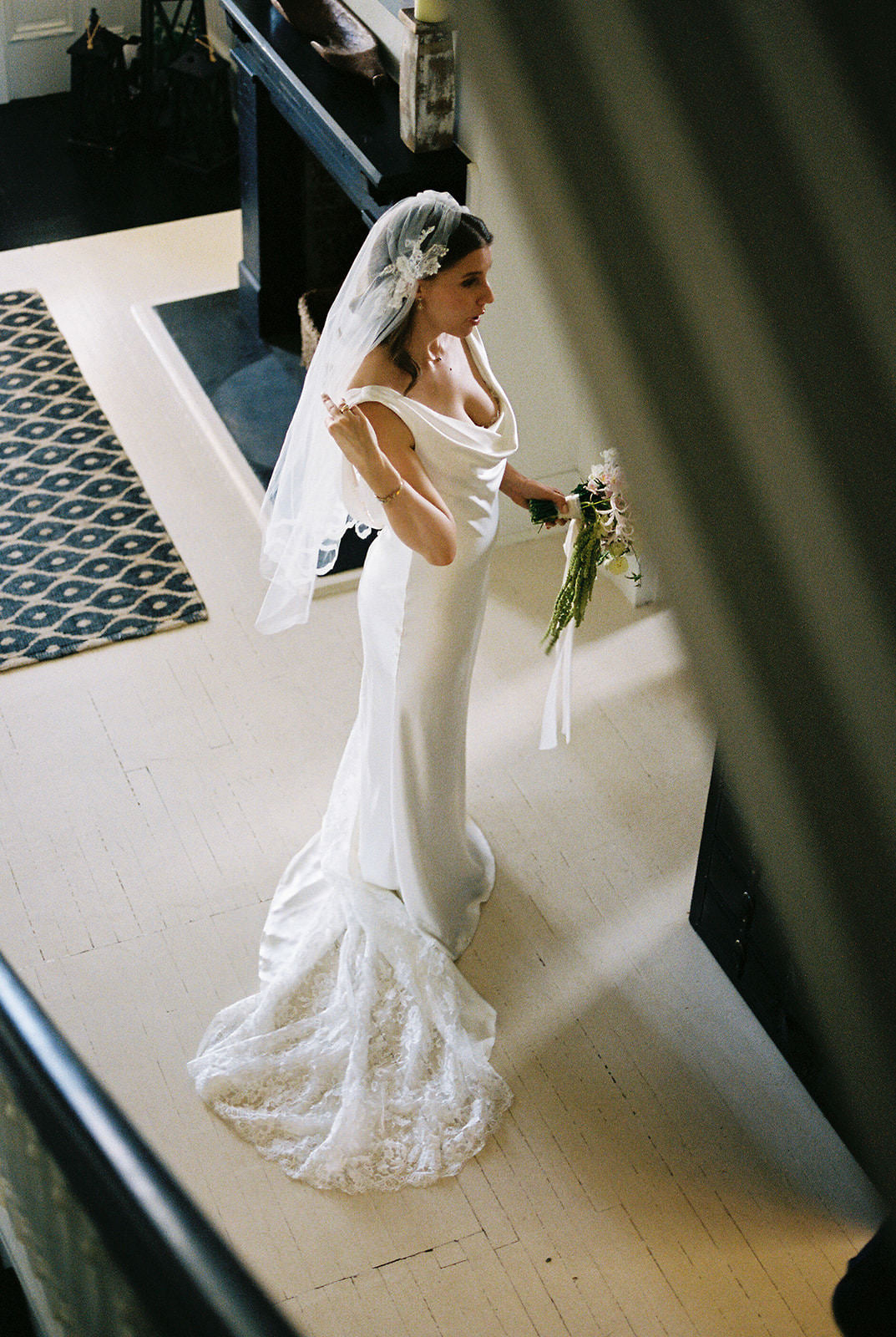 Bride in a white cowl neck wedding dress with a custom diy Juliet cap bridal veil with lace appliqués on head