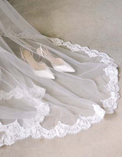 White pump wedding shoes with a long lace Matilda wedding veil with fringe edges