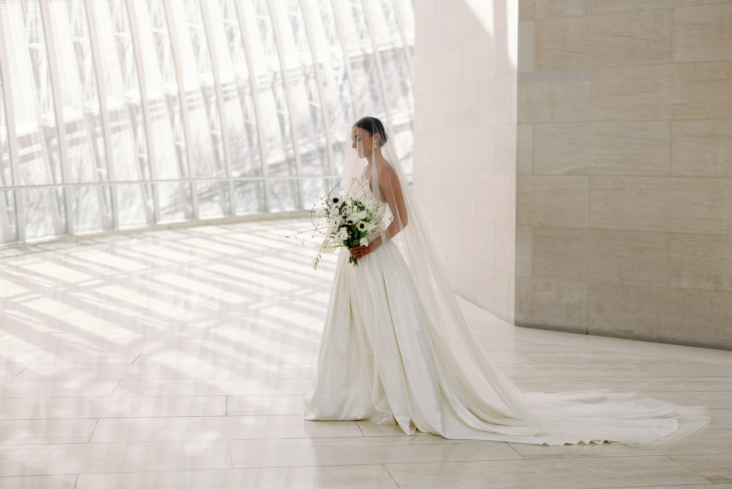 drop circle cut cathedral length wedding veil on bride in modern museum wedding venue