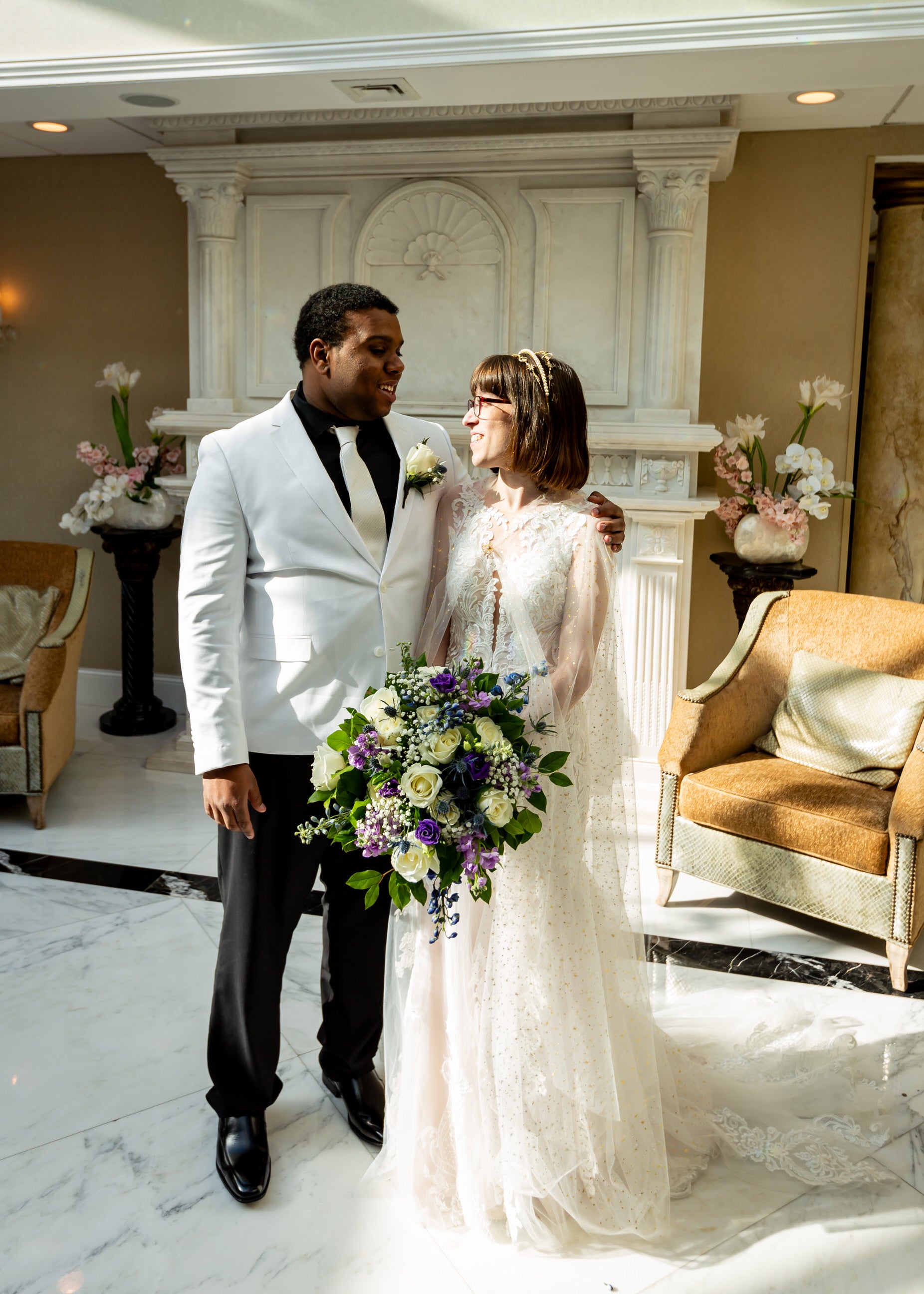 ethereal bride wearing long sparkly bridal cloak wrap smiling at groom