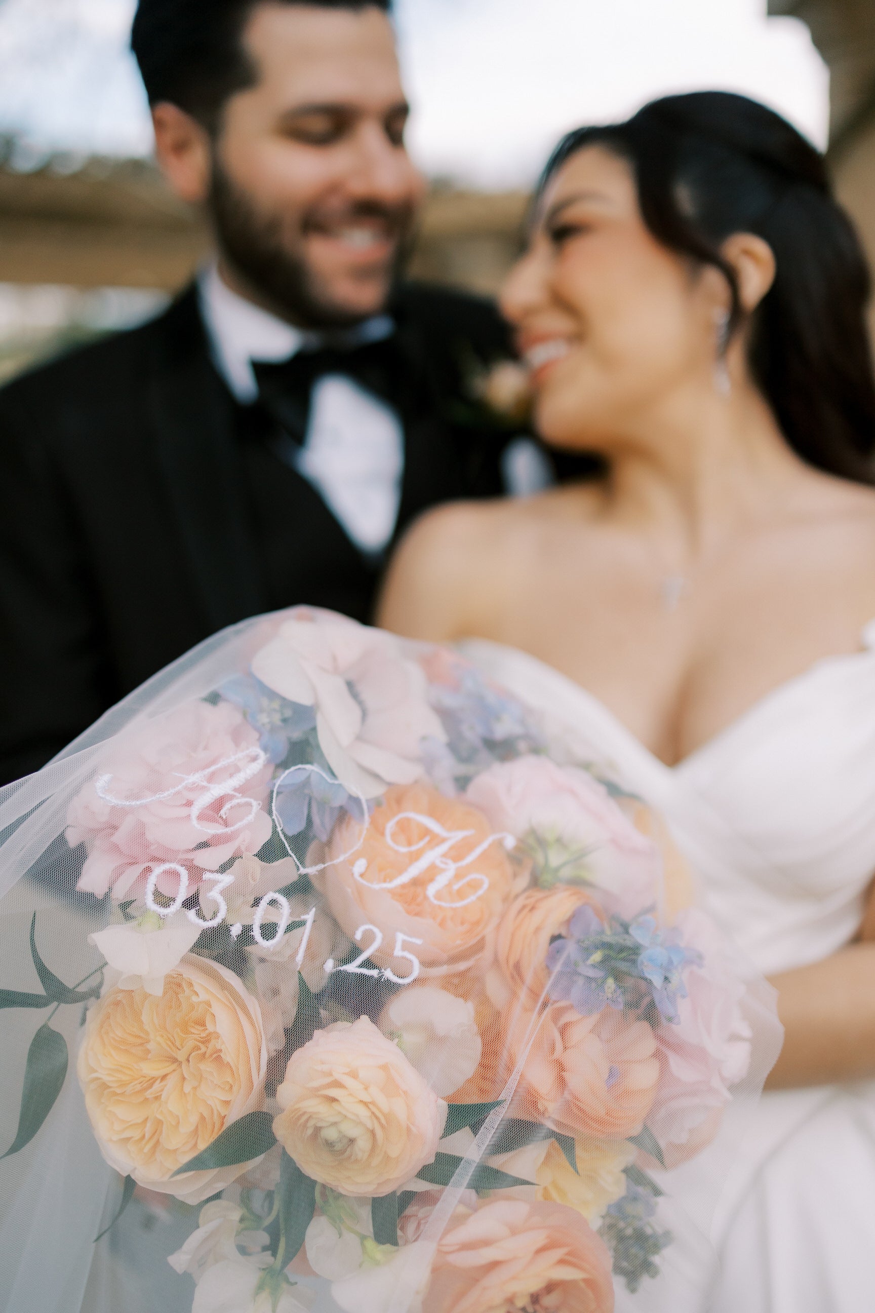 engaged couple initials embroidered on wedding veil with wedding date