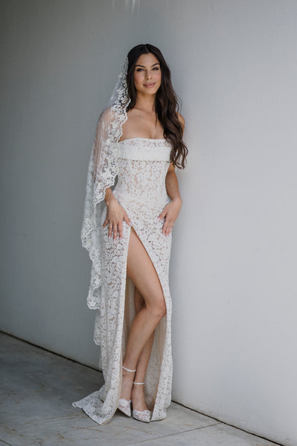 sultry slit wedding dress and long traditional lace bridal veil with corded scallop edges