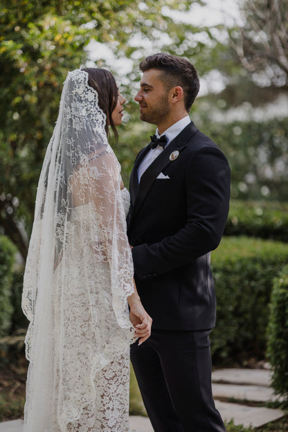 middle eastern couple with sexy bride wearing chantilly long lace trimmed mantilla on back of hair that is down and loose