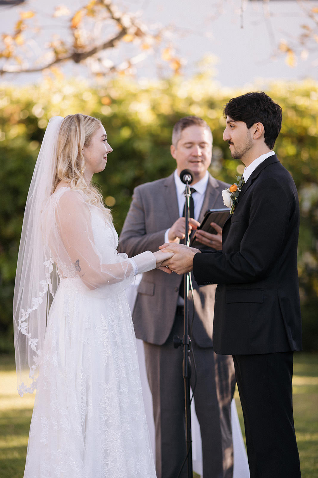 bridal veil with winding leaves on bride wearing curled downdo