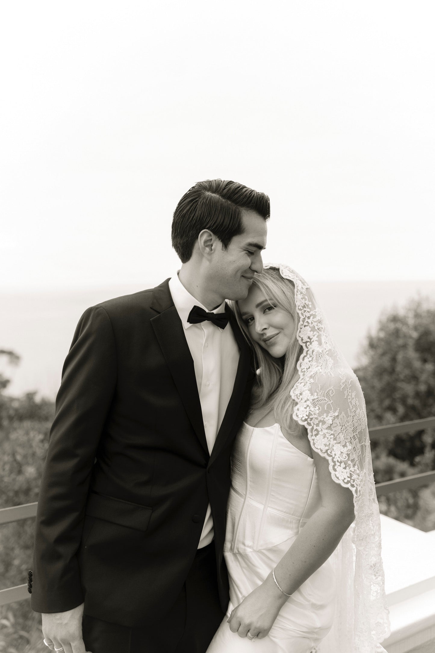circle cut mantilla wedding veil with lace trim on bride in strapless corset gown