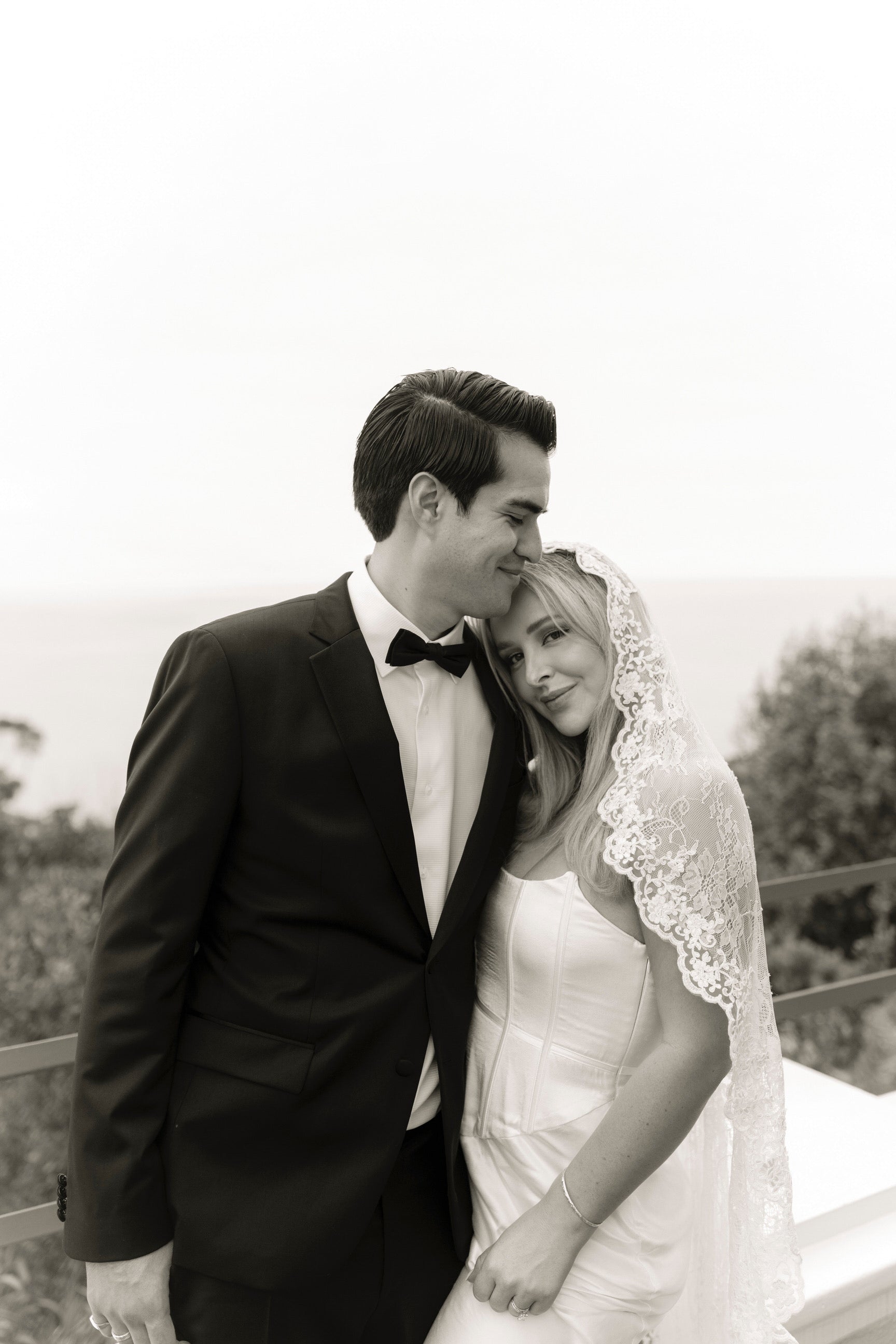 circle cut mantilla wedding veil with lace trim on bride in strapless corset gown