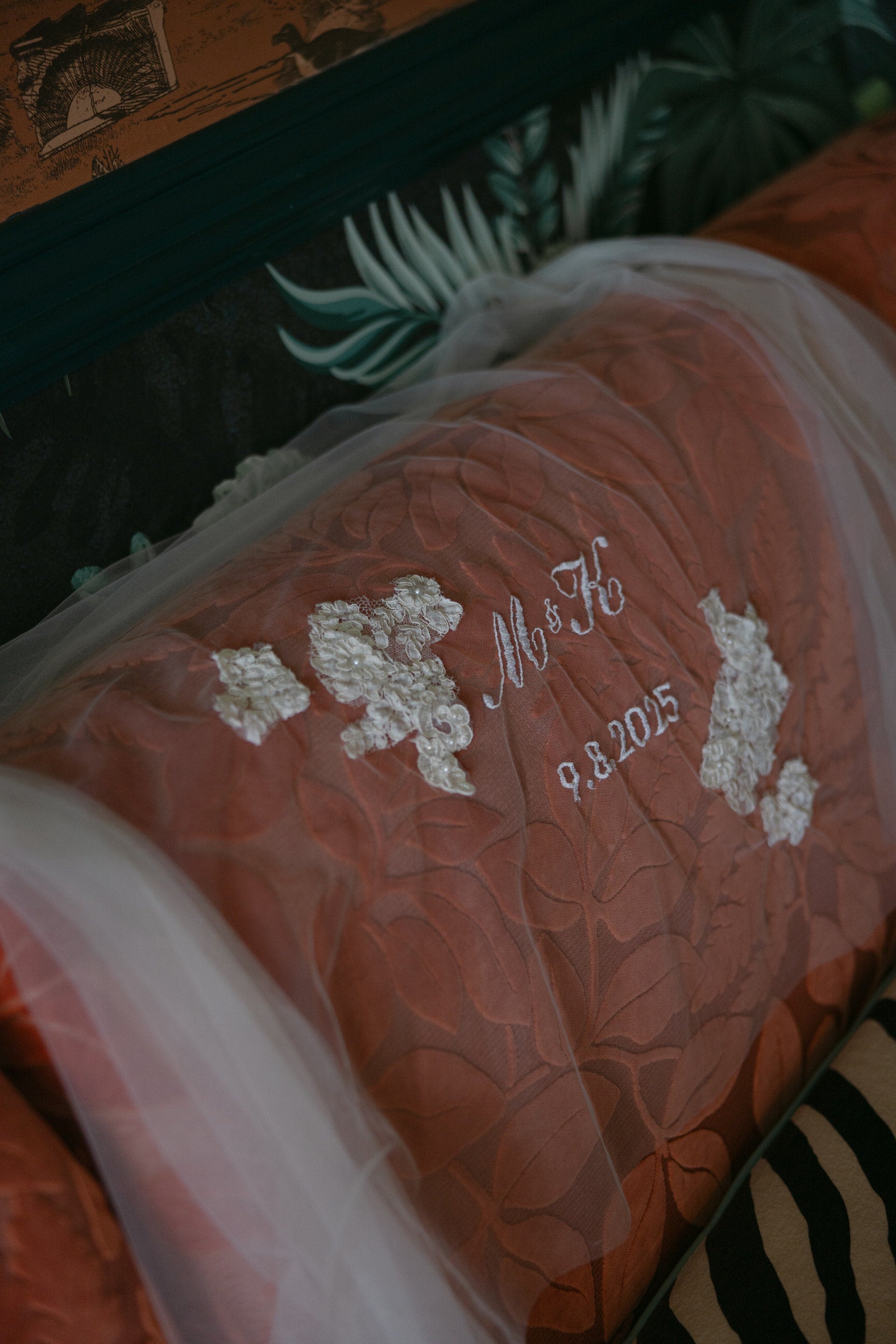 Decorative pillow at San Diego hotel with embroidered wedding veil for unity ceremony