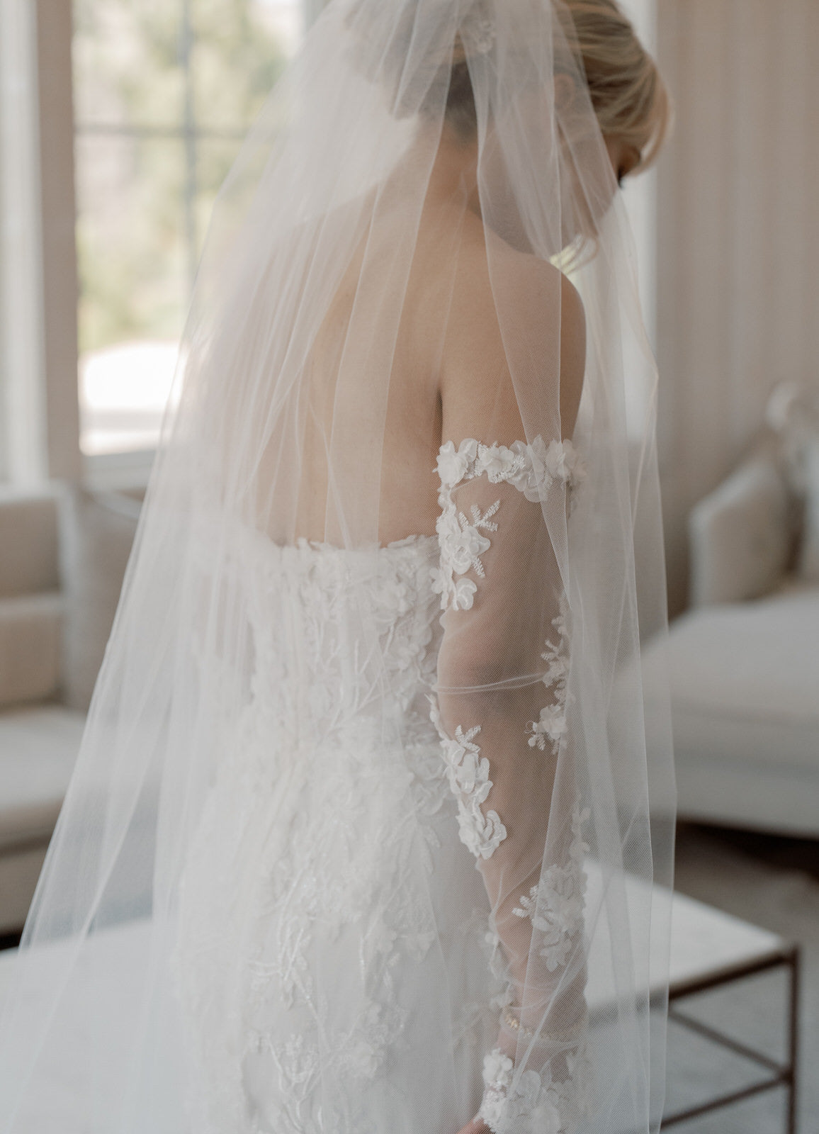 Bride in a wedding dress with floral details DIY bridal tulle sleeves for budget brides