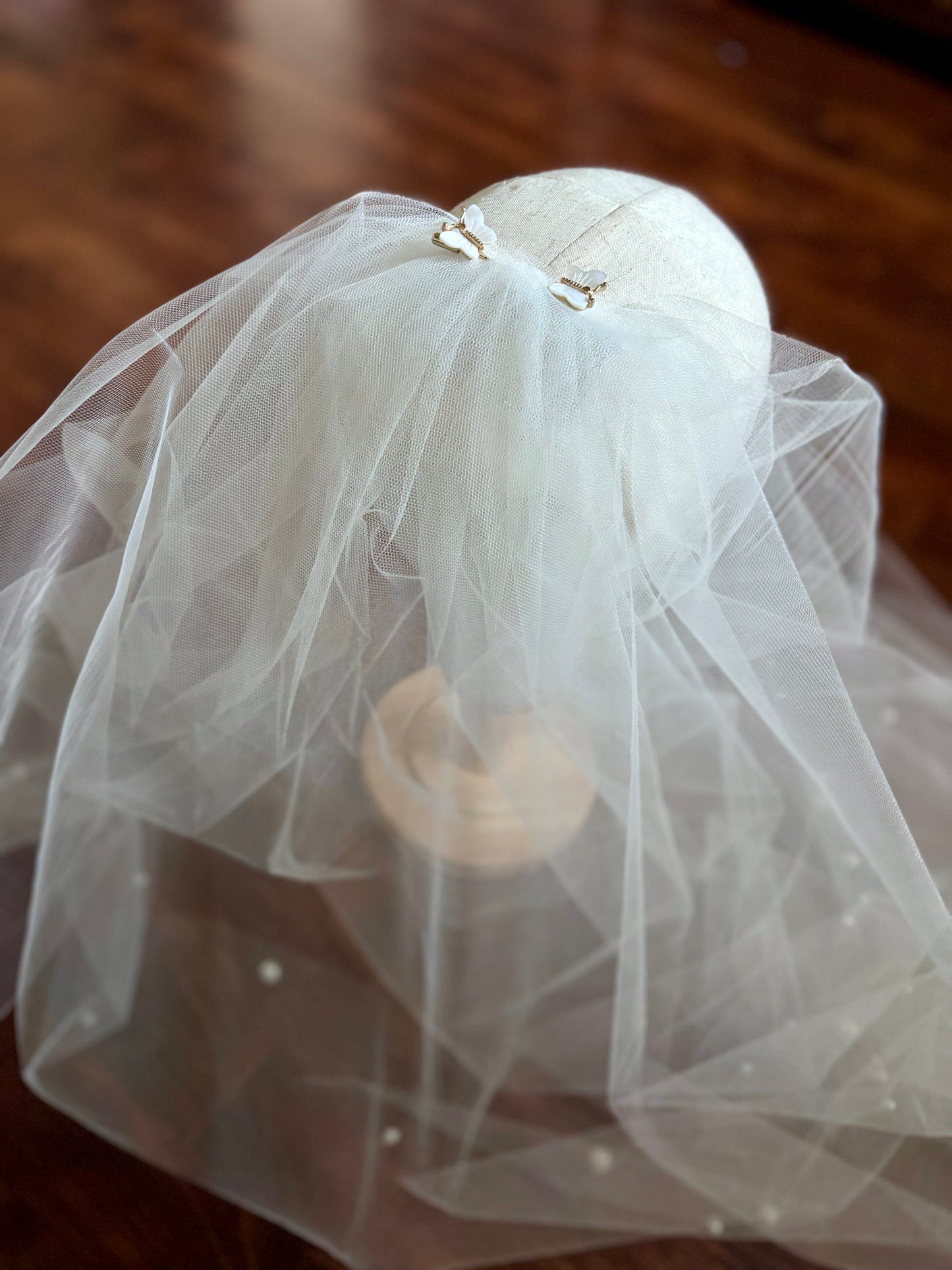 butterfly hair bustle with gold and white opal in long bridal veil