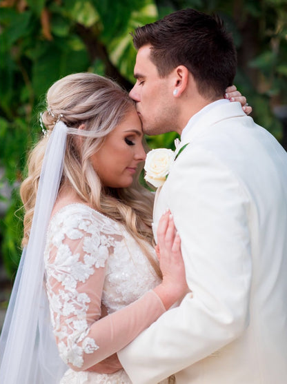 beach wedding inspiration with draped cape veil in bride's half up half down hairstyle