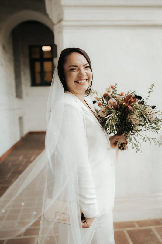 modern white pantsuit with scattered rhinestone wedding veil