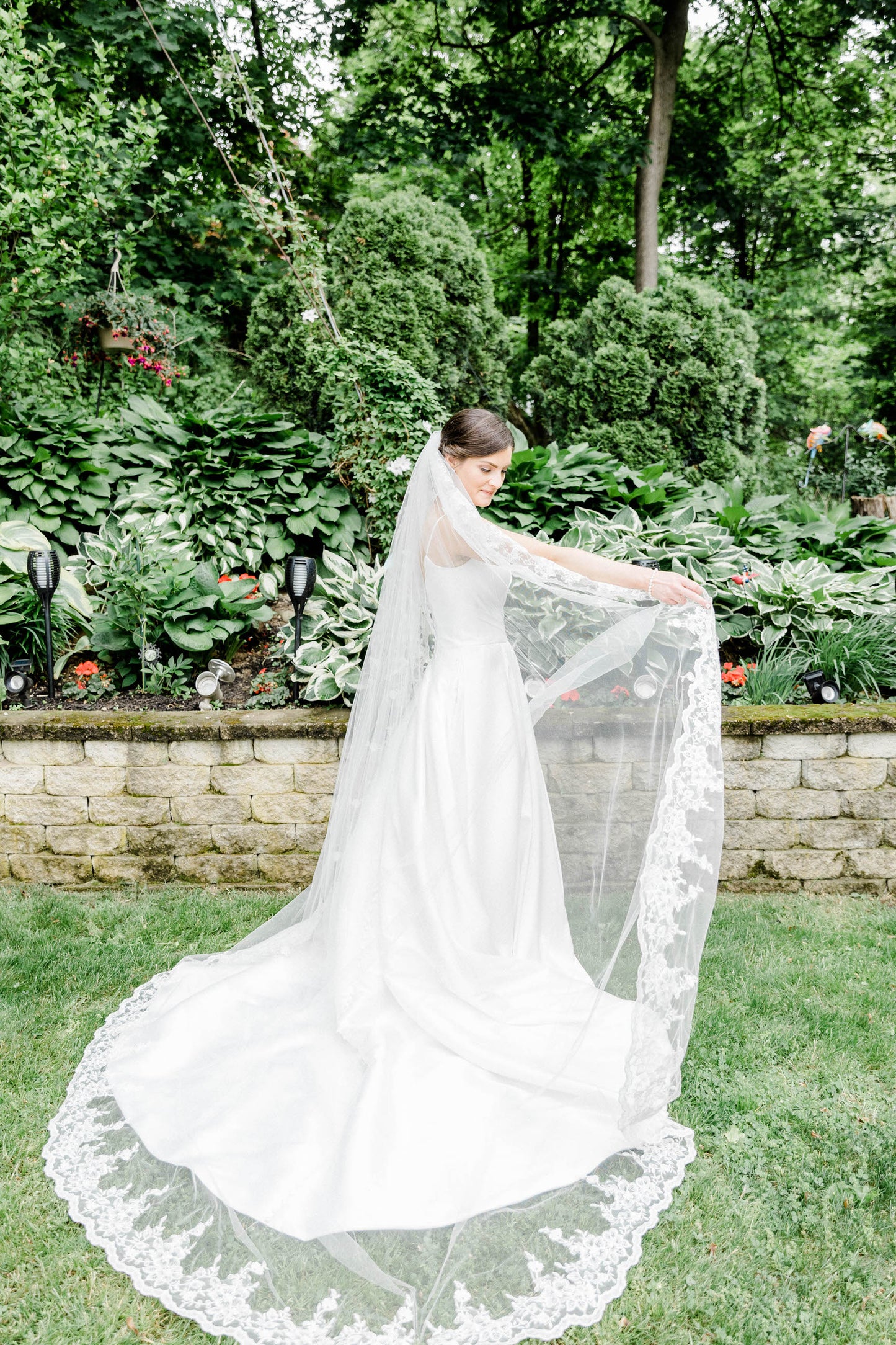 elegant formal long royal length bridal veil with whimsical flower edged lace trim and botanical cactus backdrop in garden