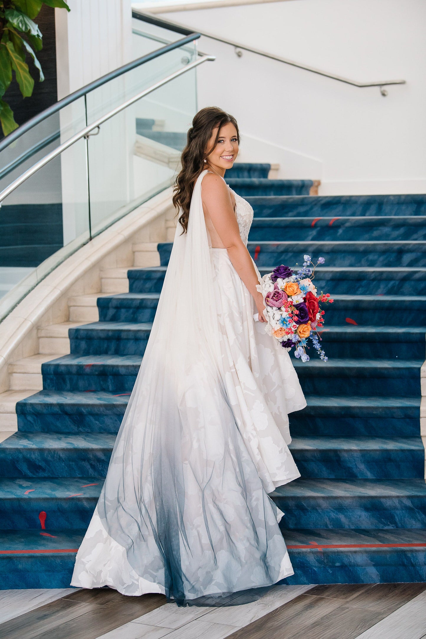 bright blue bridal cape veil on blue staircase