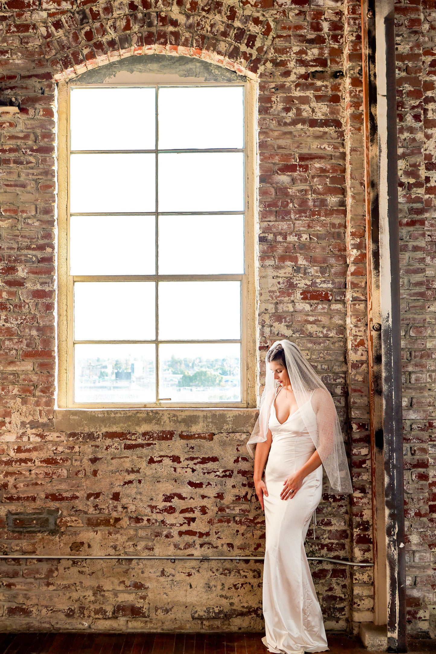 city downtown wedding with bride in hip length swiss dot polka dot wedding veil in off white