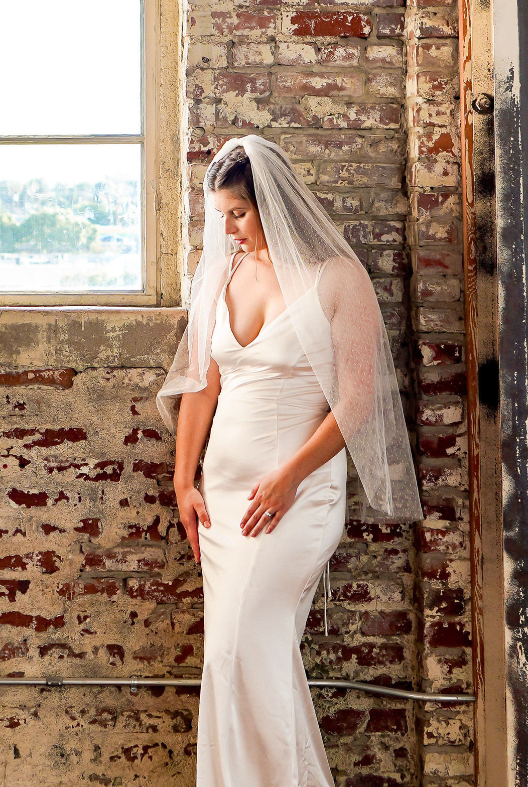 ivory Point d' Esprit bridal veil on elegant bride with hair down wearing silk sheath gown