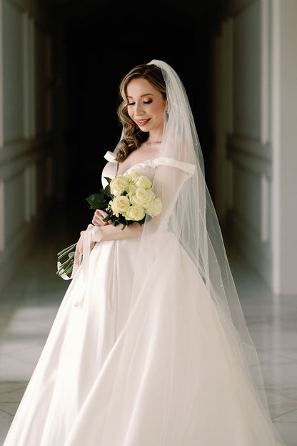 formal black tie wedding with scattered pearl wedding veil and yellow rose bouquet